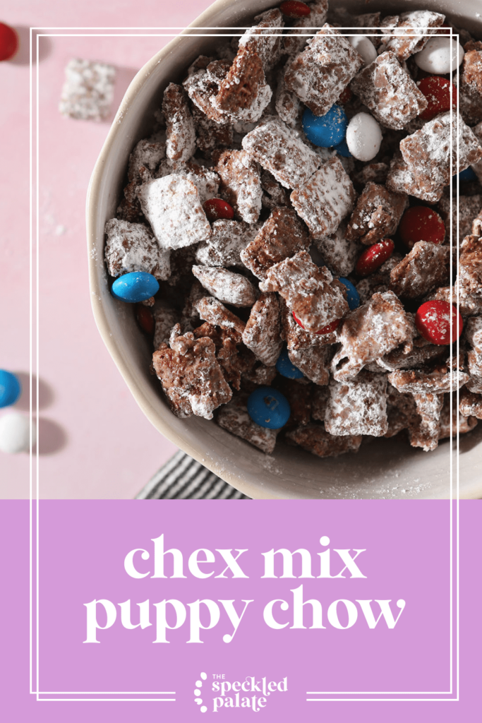 Close up of a bowl of puppy chow with red, white and blue candies with the text chex mix puppy chow