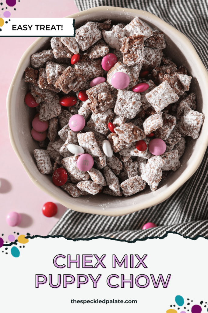 A bowl holding Puppy Chow with red, white and pink chocolate-coated candies with the text 'chex mix puppy chow'