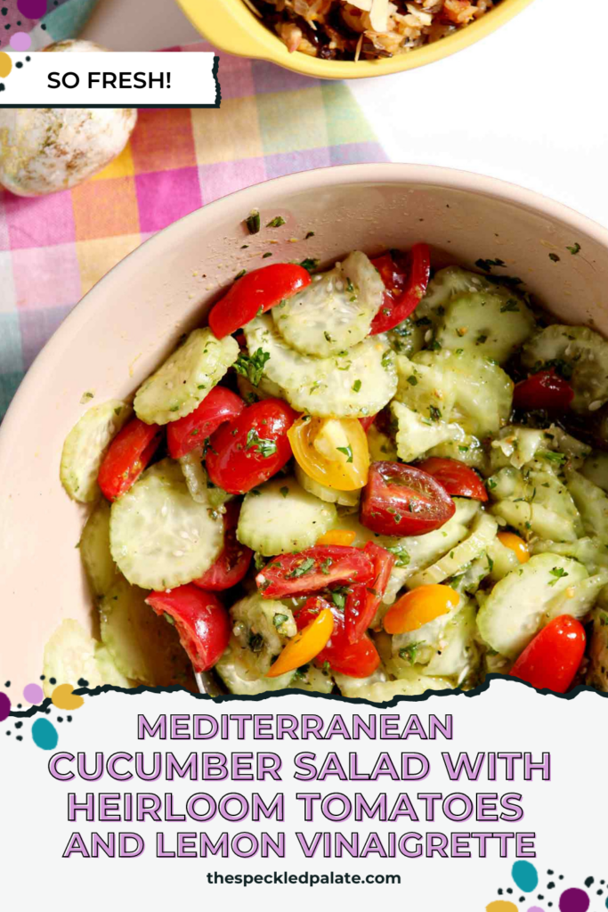 Close up of a bowl holding a cucumber and tomato salad with the text Mediterranean Cucumber Salad with Heirloom Tomatoes and Lemon Vinaigrette