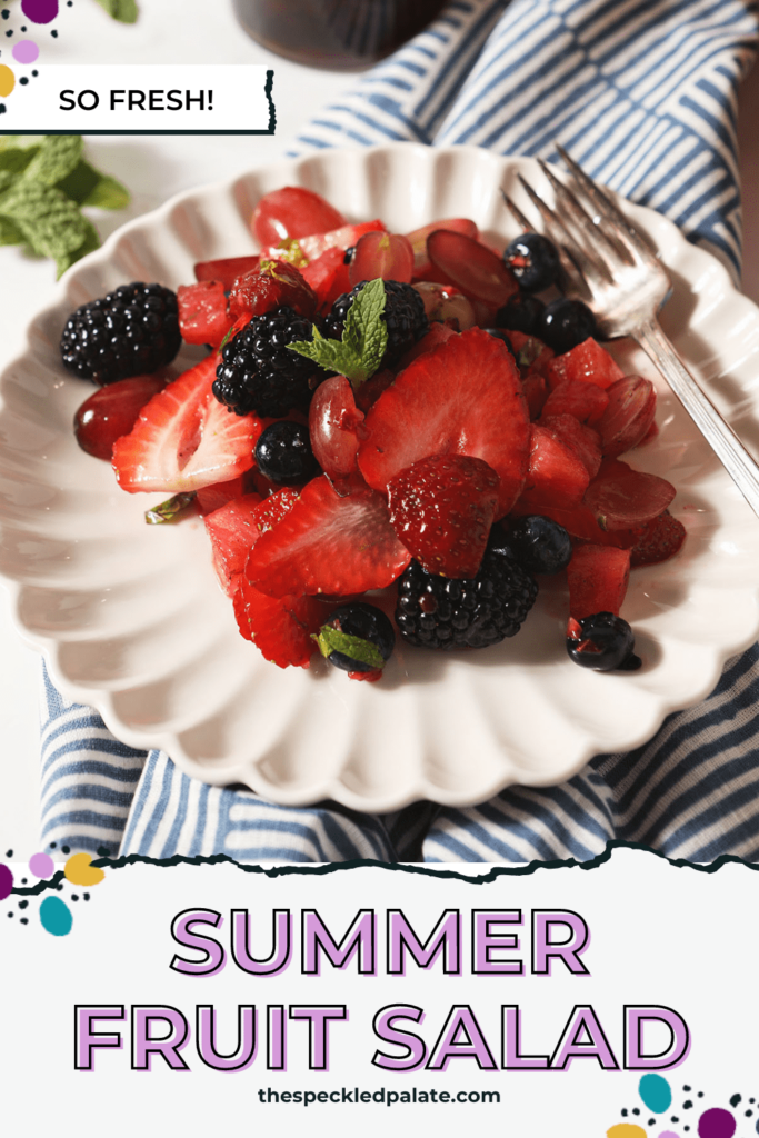 A plate of berry fruit salad with watermelon in front of a jar of honey with the text Summer Fruit Salad