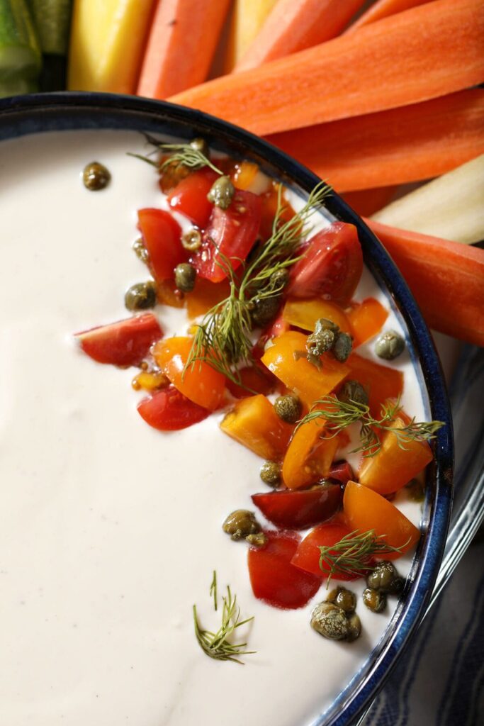 Close up of tomato-dill garnishes on top of whipped feta dip recipe