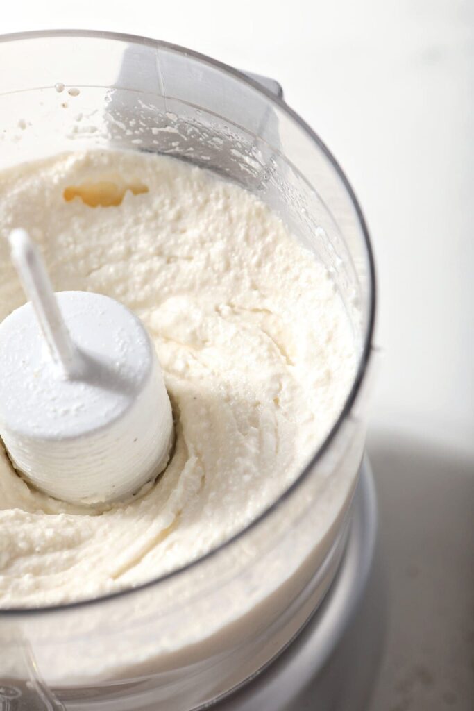 Blended ingredients for feta dip in a food processor