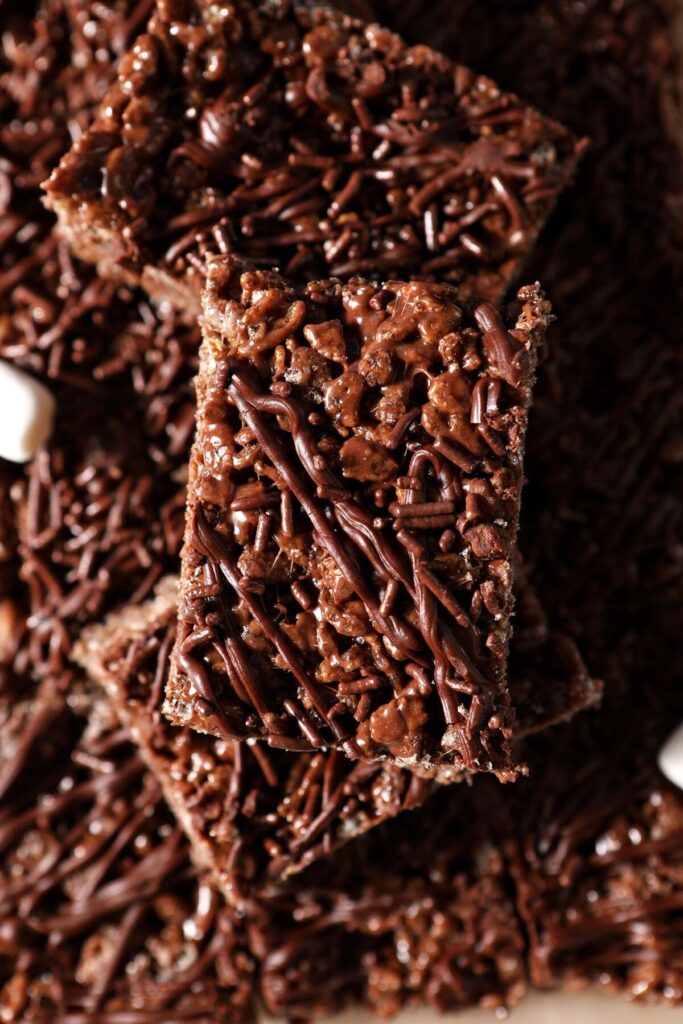 Close up of sliced Chocolate Rice Krispie Treats on top of each other with mini marshmallows