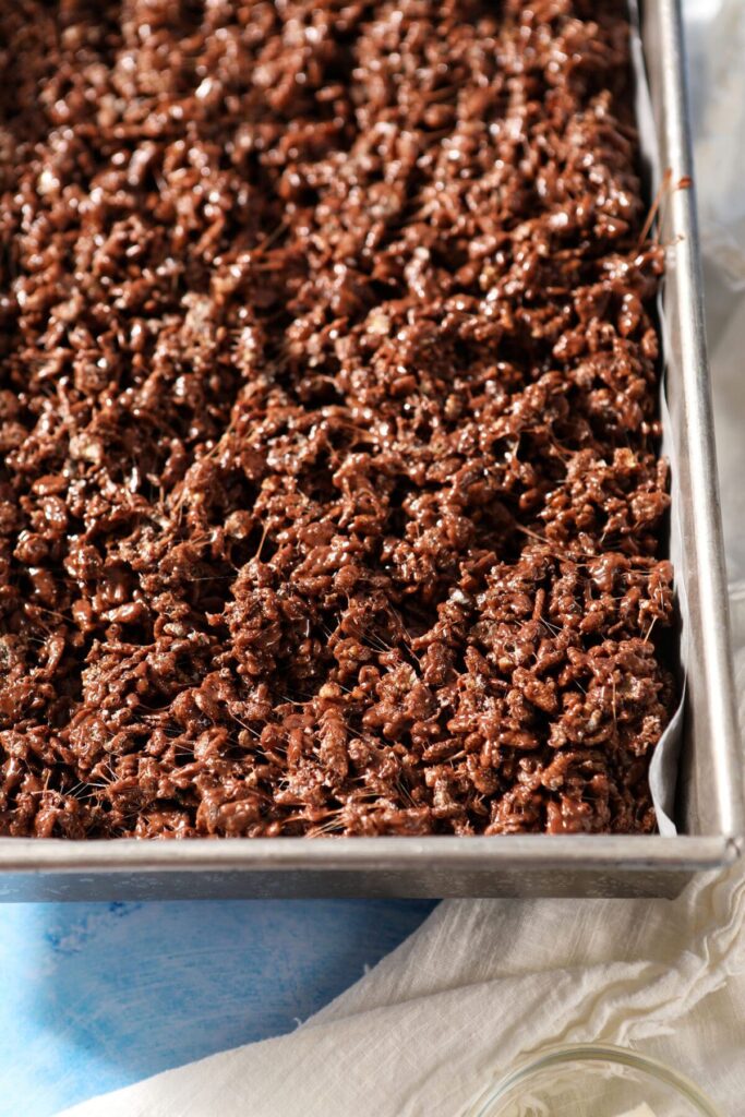 Homemade Chocolate Rice Krispie Treats are the best no bake dessert for any chocolate lover. All you need are 6 simple ingredients to make these chocolate krispie rice treats. Learn how to make them your own here! Makes 24 treats. Chocolate Rice Krispie Treat batter in a pan