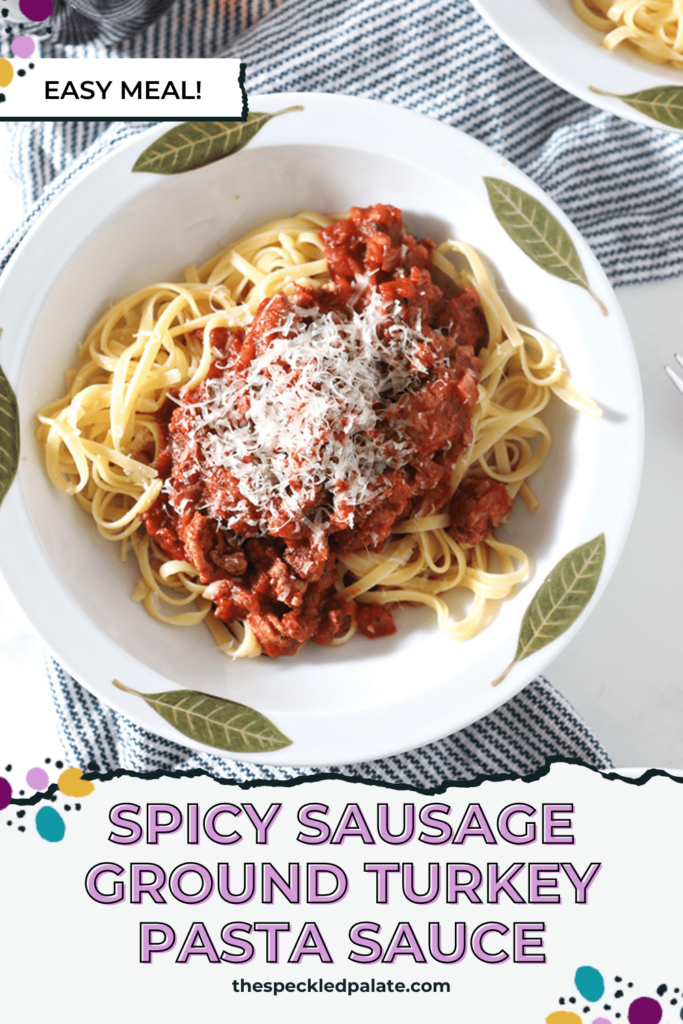 Close up of a bowl of turkey pasta sauce topped with shredded cheese with the text spicy sausage ground turkey pasta sauce