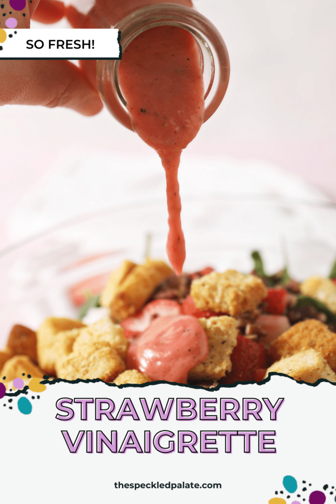 Strawberry salad dressing drizzles on top of a salad with croutons, cheese and more with the text Strawberry Vinaigrette