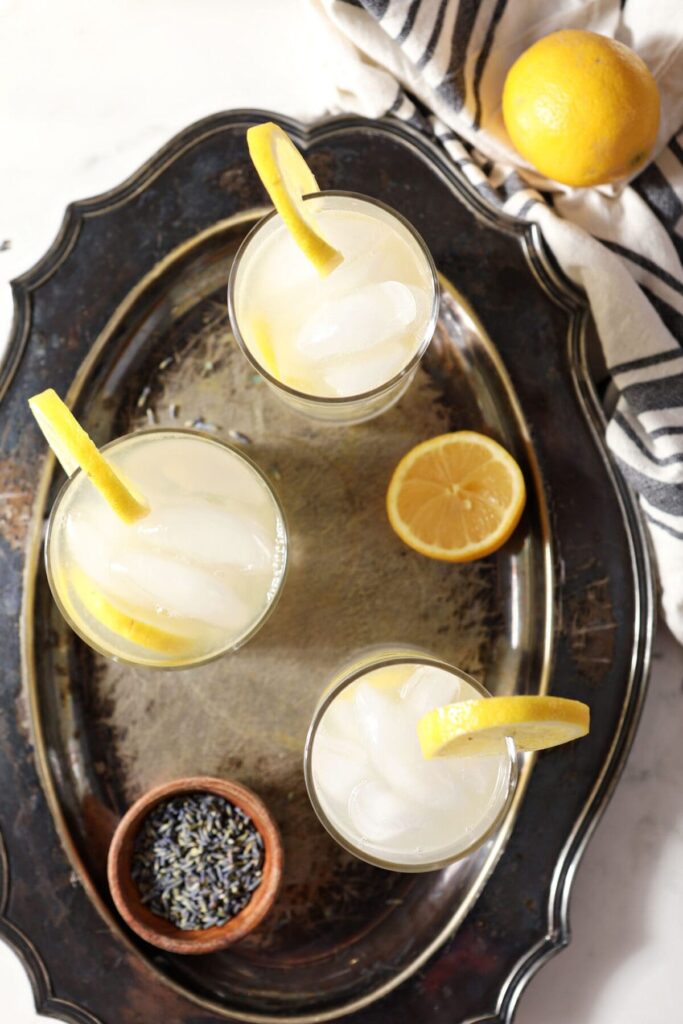 Overhead of three glasses of lemonade garnished with lemon wheels