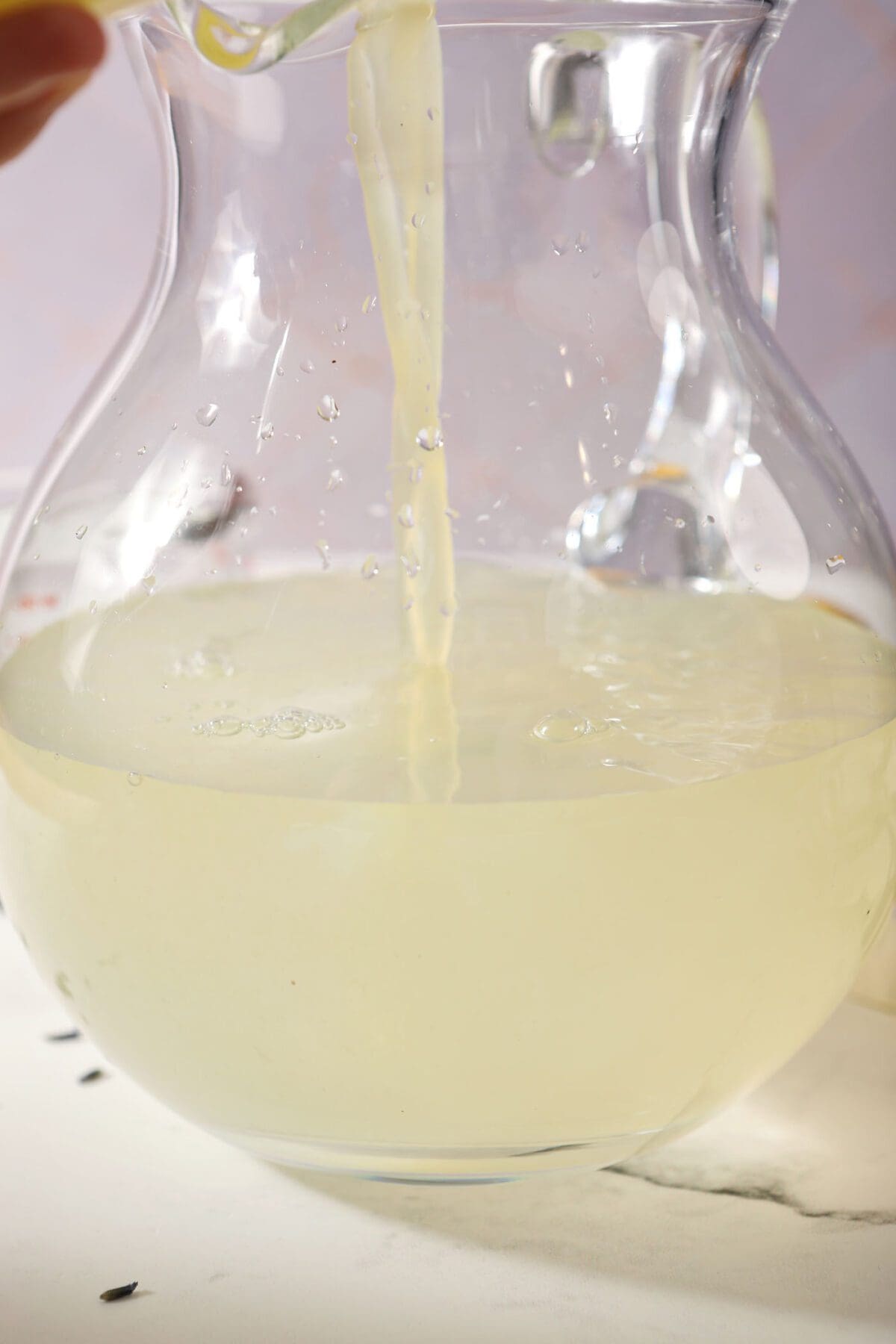 Lemon juice pours into water to make lemonade