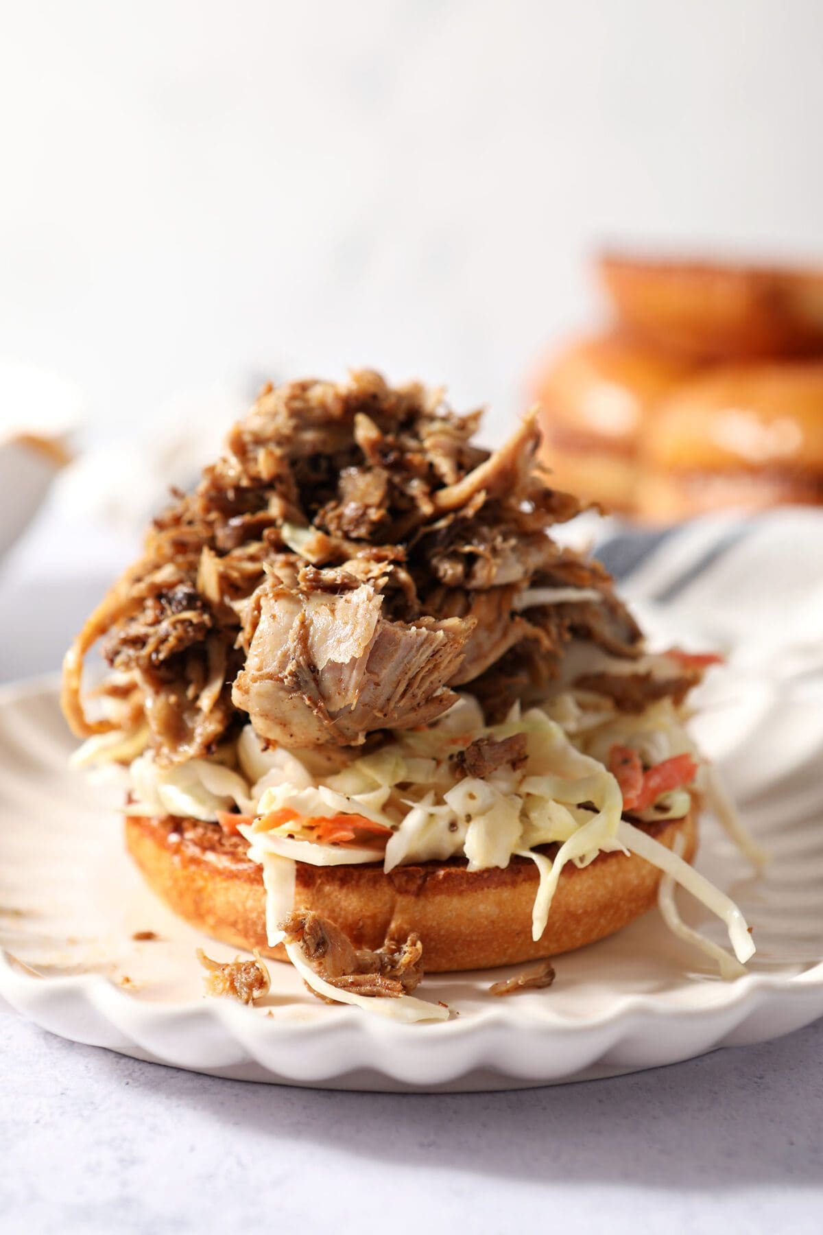 Pulled pork on top of slaw on a bun