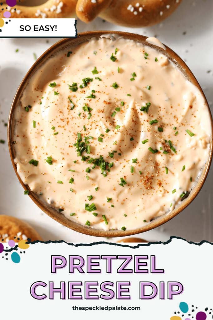 Close up of cheese dip garnished with paprika and chives and surrounded by soft pretzels with the text Pretzel Cheese Dip