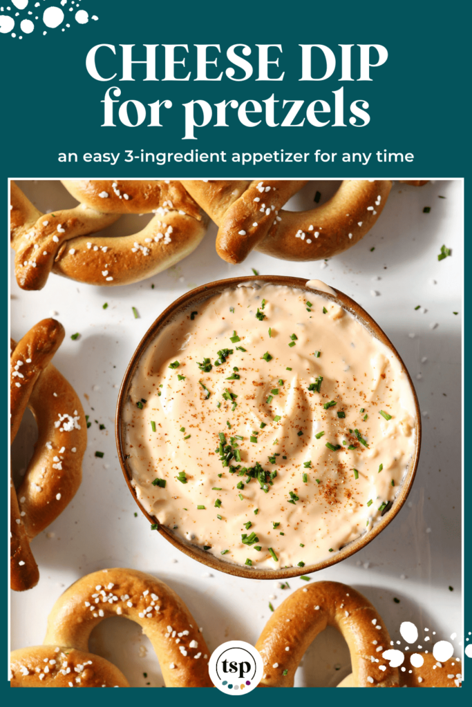 A bowl of cheese dip garnished with paprika and chives and surrounded by soft pretzels with the text pretzel cheese dip with the text cheese dip for pretzels an easy 3-ingredient appetizer for any time