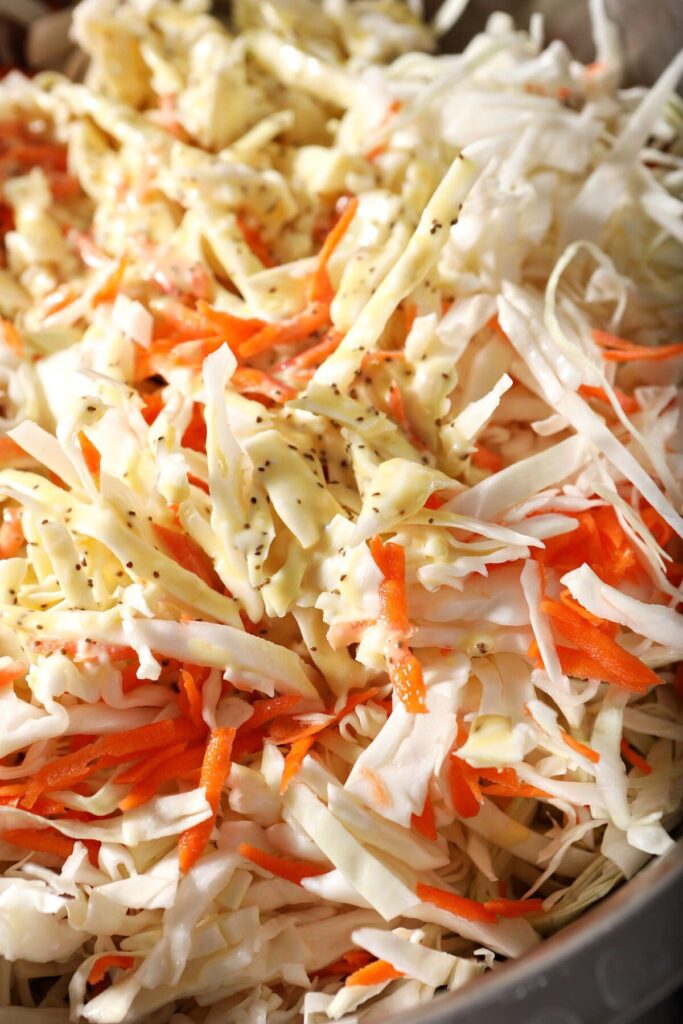 Close up of slaw drizzled with dressing