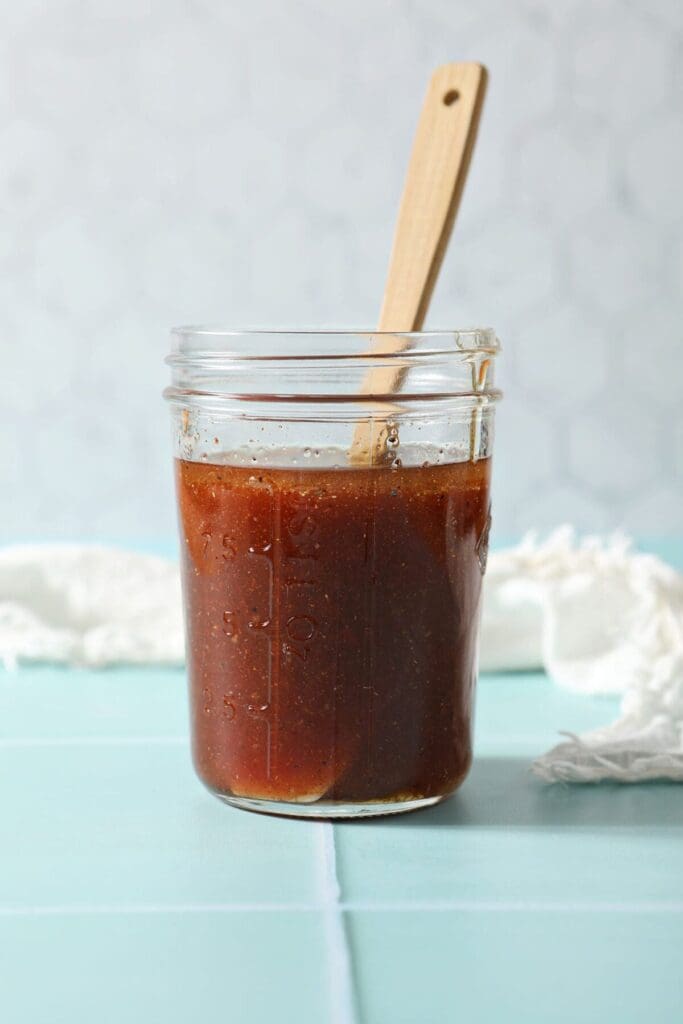 A mason jar of Catalina dressing with a stirrer inside it