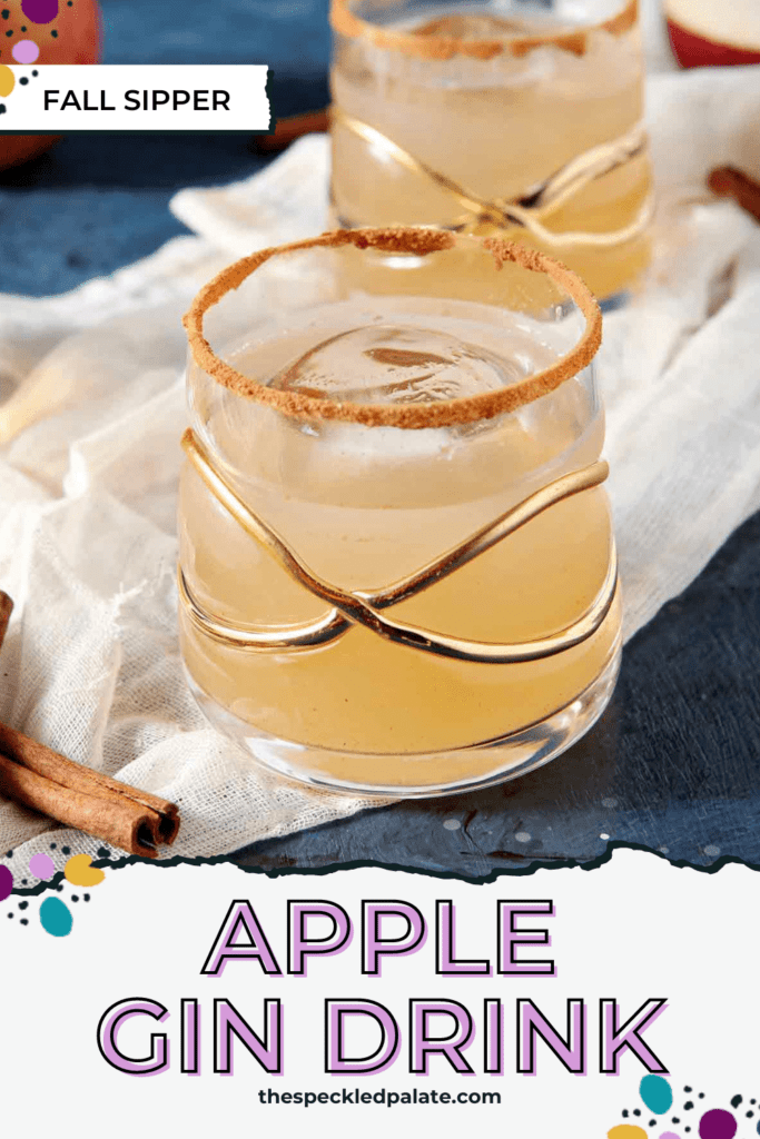 Closeup of a fancy gold-decorated glass holding a brown cocktail with the text apple gin drink