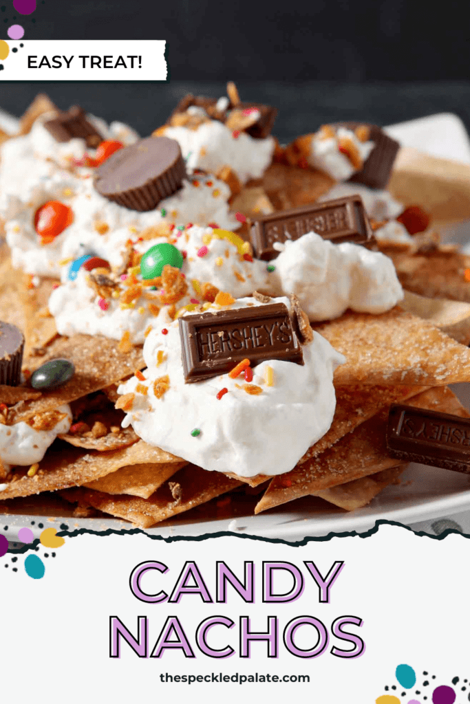 A plate of sweet dessert nachos piled high with whipped cream and various candies with the text Candy Nachos