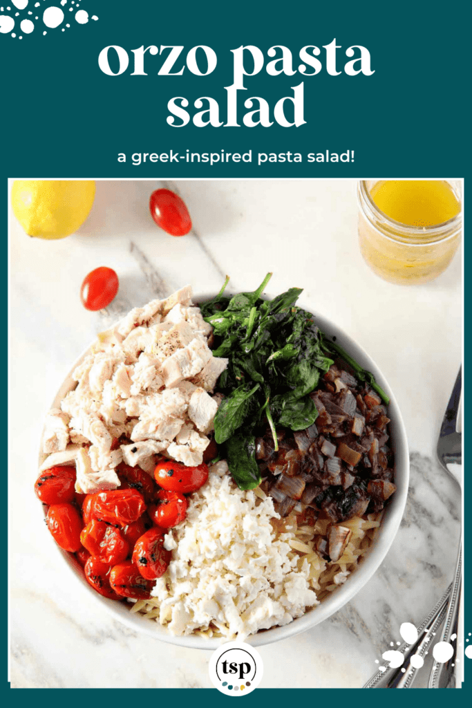 A bowl of ingredients, including charred tomatoes, chicken, wilted spinach, red onion and feta cheese in a bowl on marble with the text orzo pasta salad a greek-inspired pasta salad