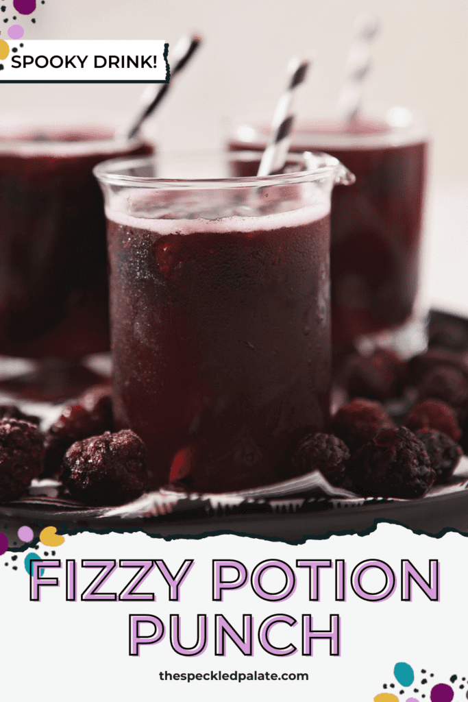 Close up of a nonalcoholic Halloween Punch, garnished with frozen blackberries and a paper straw with the text Fizzy Potion Punch