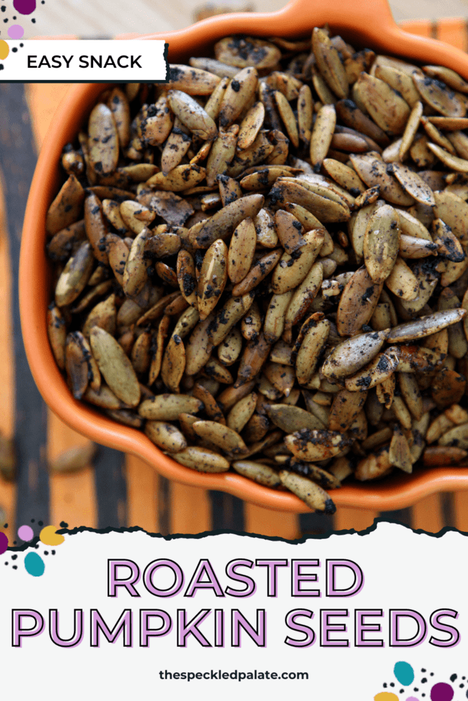 Overhead of an orange pumpkin-shaped bowl full of roasted seeds with the text roasted pumpkin seeds