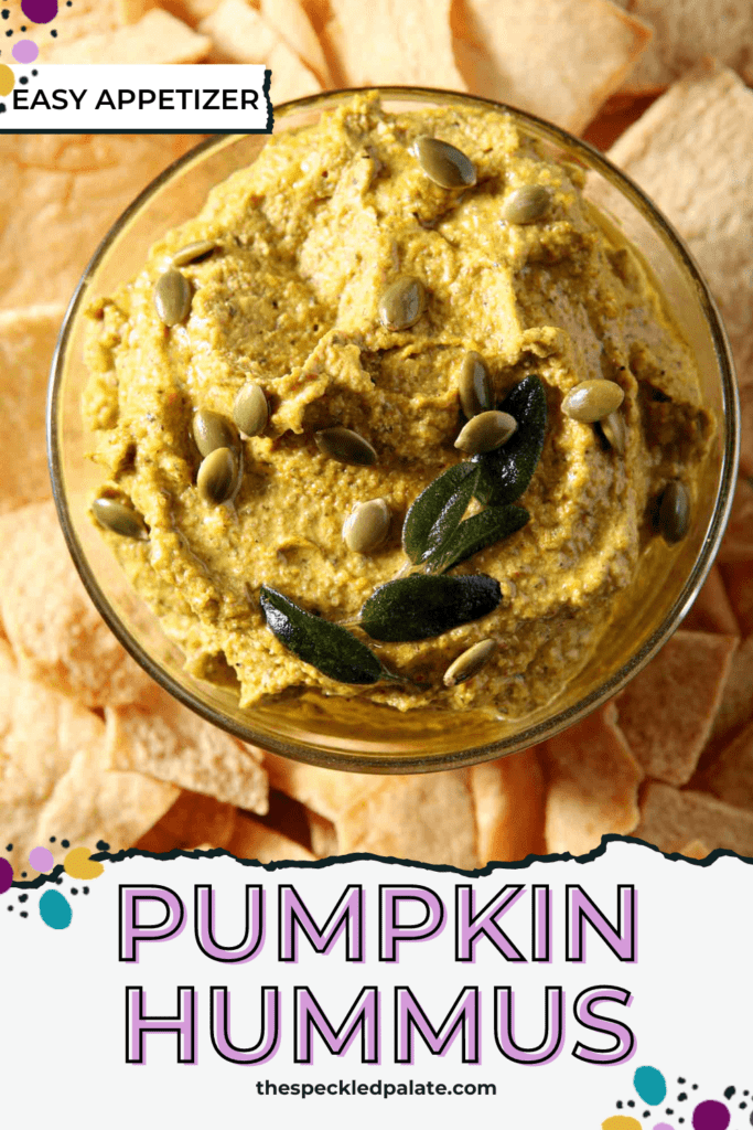 fall hummus in a glass jar on a plate surrounded by pita chips with the text pumpkin hummus