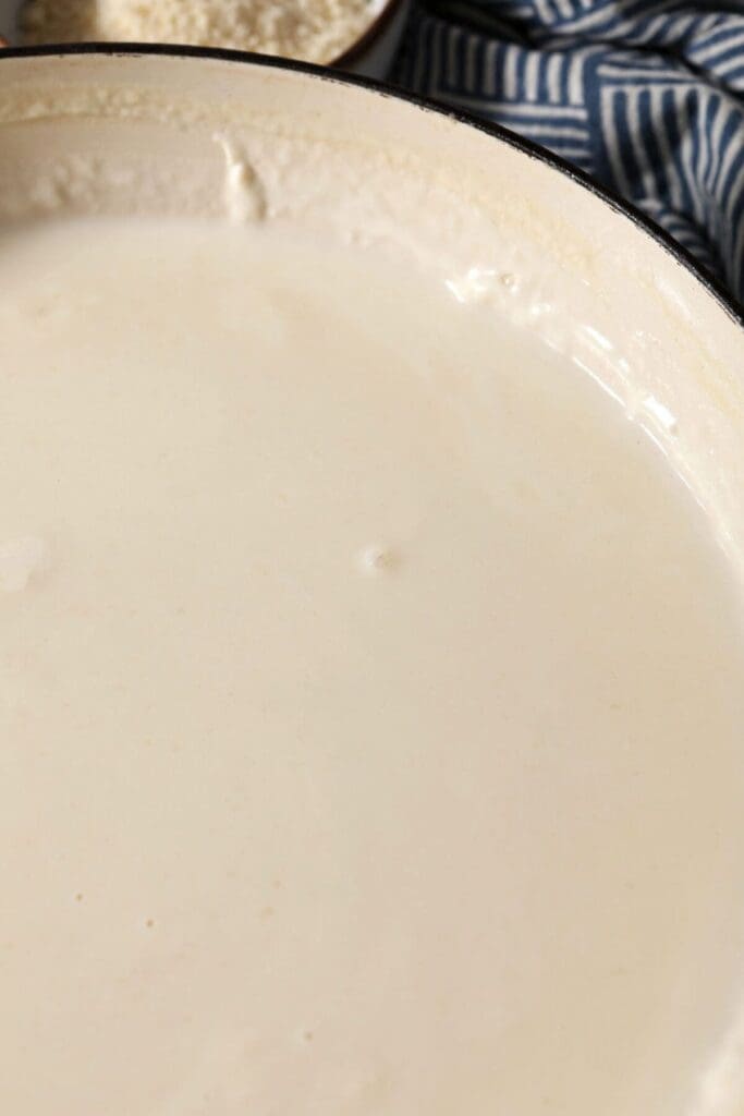 The thickened base sauce for macaroni and cheese in a pan