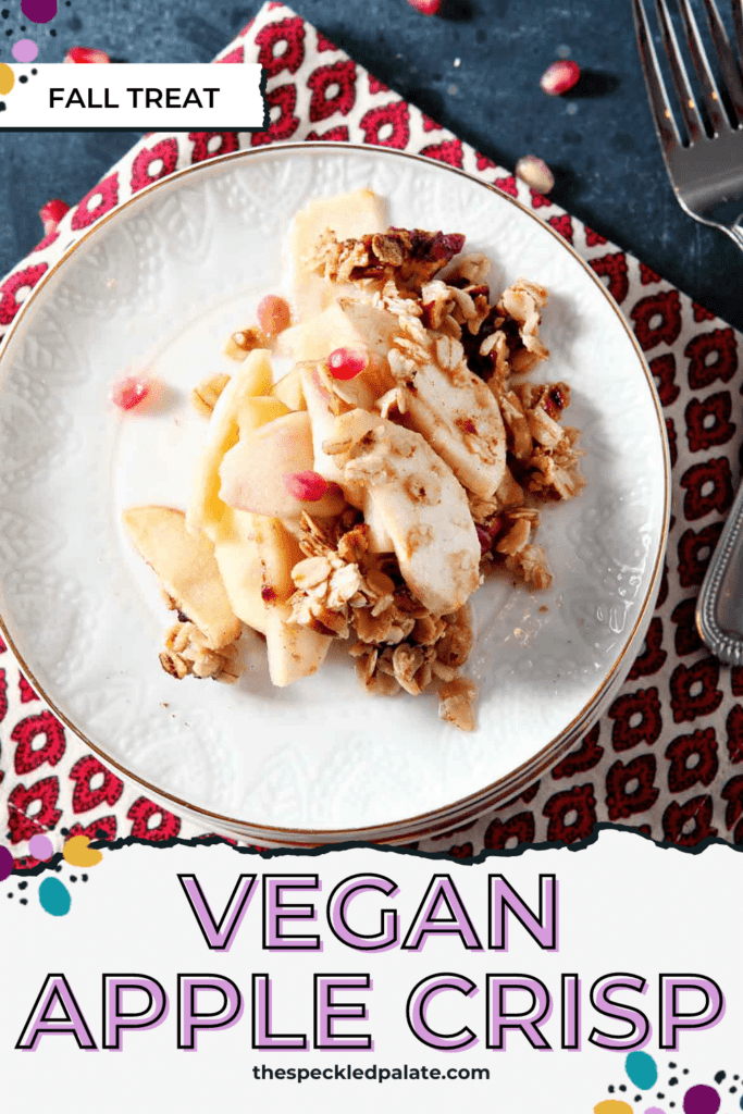 Close up of a serving of apple crisp with pomegranates on a stack of white plates with the text vegan apple crisp