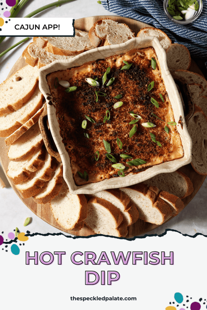 Crawfish dip in a casserole dish surrounded by baguette slices and garnished with green onion with the text Hot Crawfish Dip