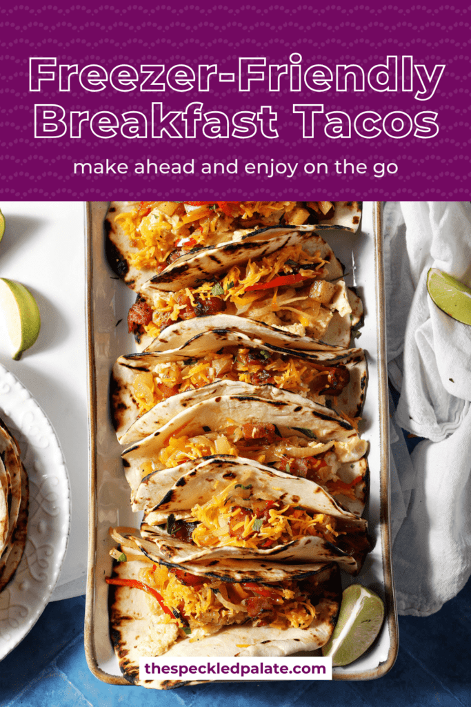 Close up of breakfast egg tacos with bacon, potatoes and veggies on a platter with the text freezer-friendly bfeakfast tacos make ahead and enjoy on the go