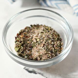 A small batch steak seasoning blend in a glass bowl on marble