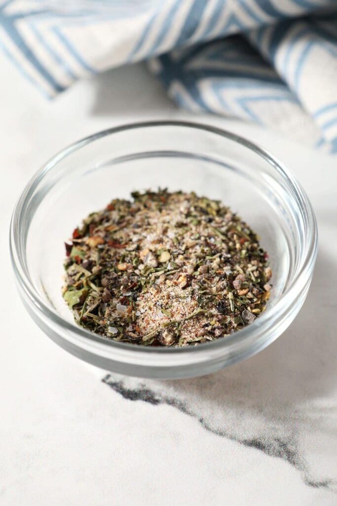 A small batch steak seasoning blend in a glass bowl on marble