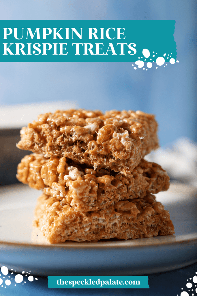 A stack of three orange rice krispie treats on a white plate on a blue surface with the text Pumpkin Rice Krispie Treats