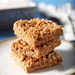 A stack of three Pumpkin Spice Rice Krispie Treats on a white plate