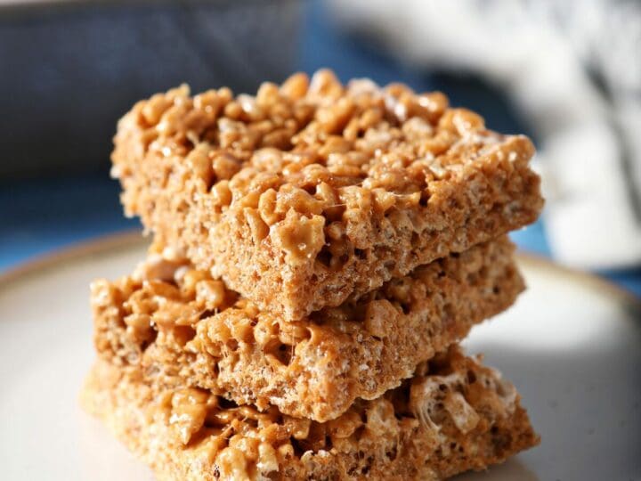 A stack of three Pumpkin Spice Rice Krispie Treats on a white plate