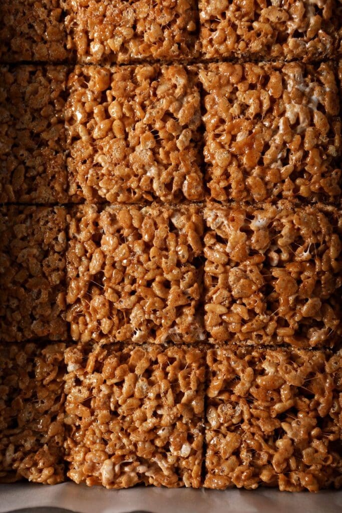 Sliced Pumpkin Spice Rice Krispie Treats in a pan