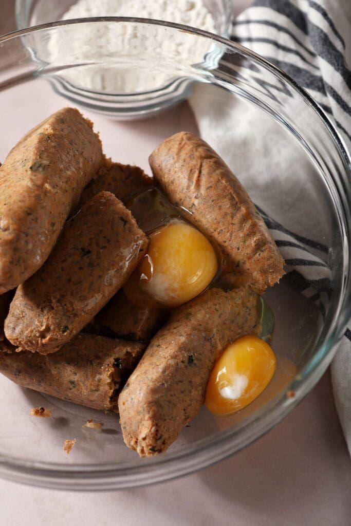 Boudin and eggs in a bowl on a light brown countertop