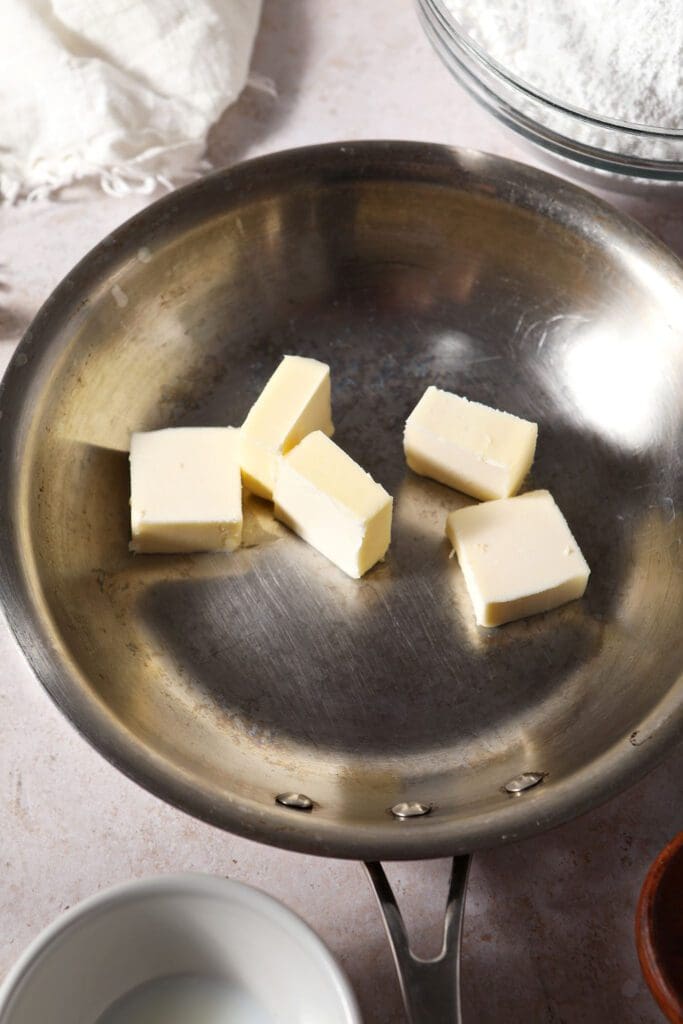 Sliced butter in a metal skillet