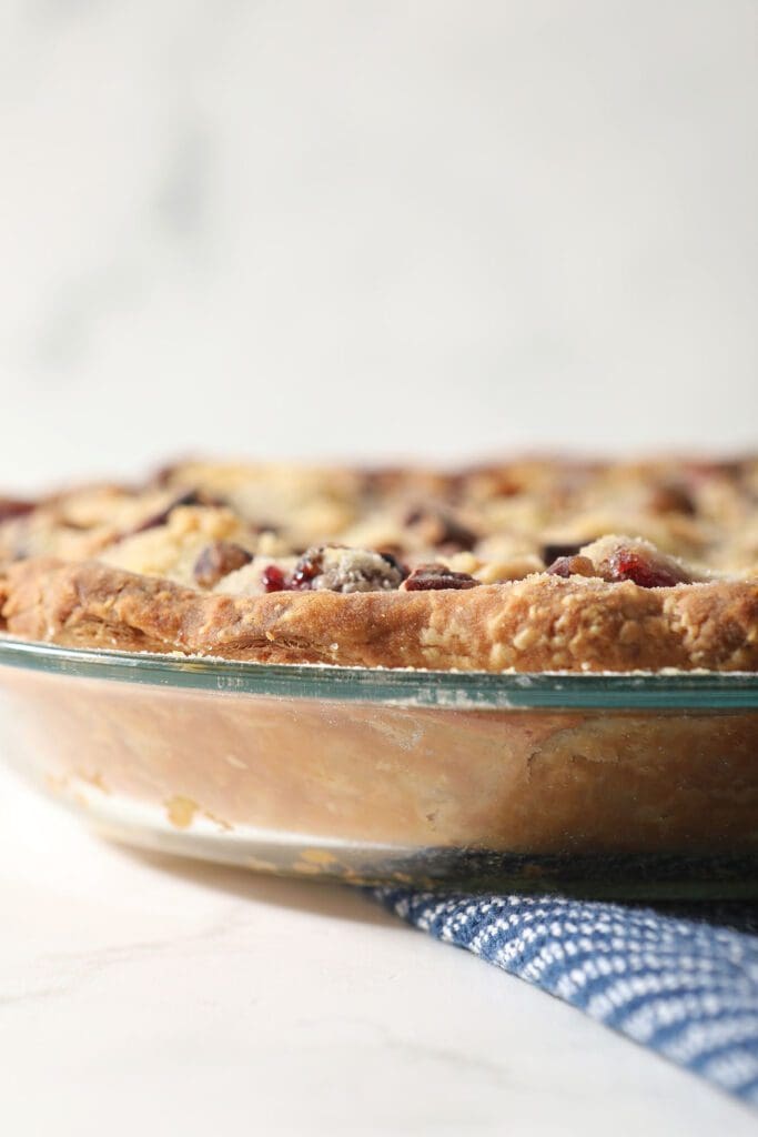 Close up of a golden brown pie crust in a glass baking dish after baking