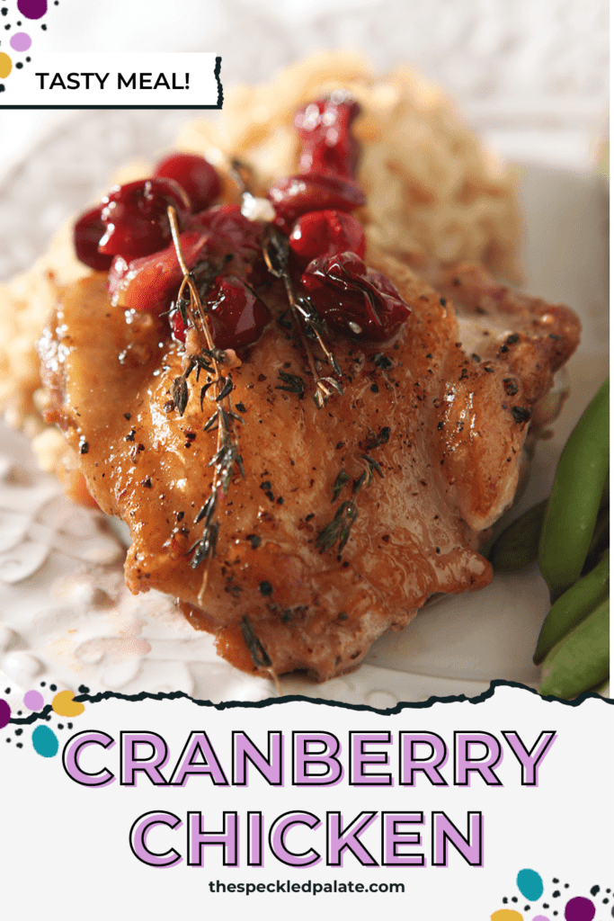 Close up of a Cranberry Chicken Thigh with brown rice and green beans on a plate with the text cranberry chicken