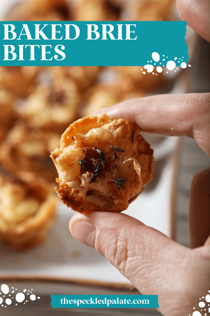 A hand holds a baked brie bite in front of a white platter of more brie bites with the text baked brie bites