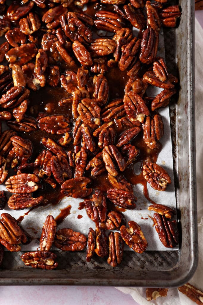 Glazed pecans on a sheet pan after cooling