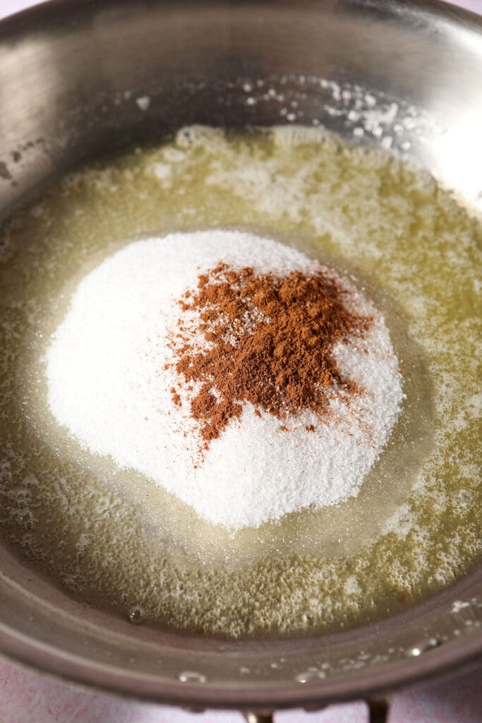 Sugar with cinnamon and melted butter in a skillet