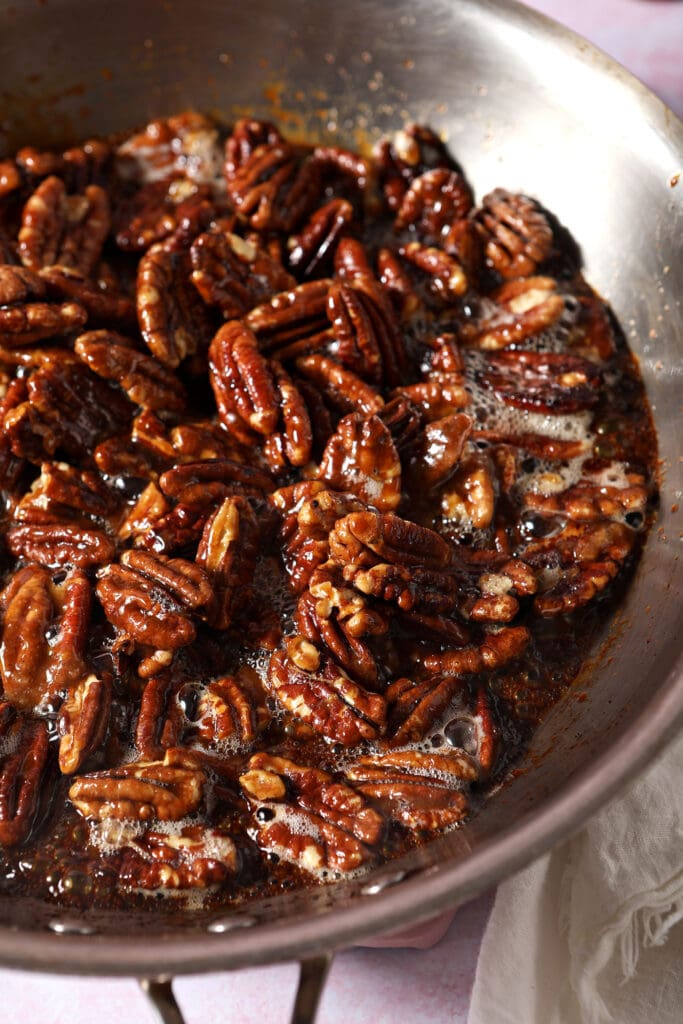 Glazed pecans in a skillet