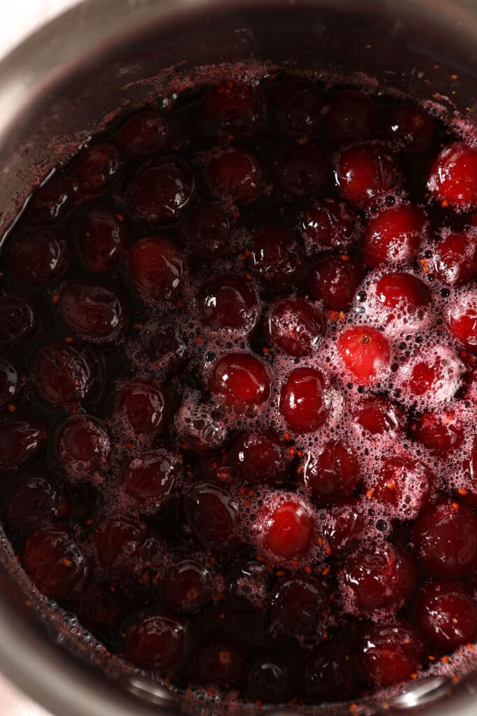 Close up of boiled cranberries in a saucepan