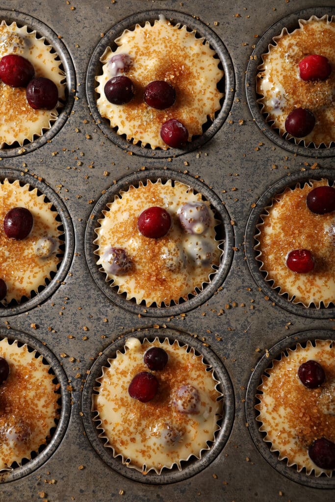 Cranberry muffin batter in a tin before baking