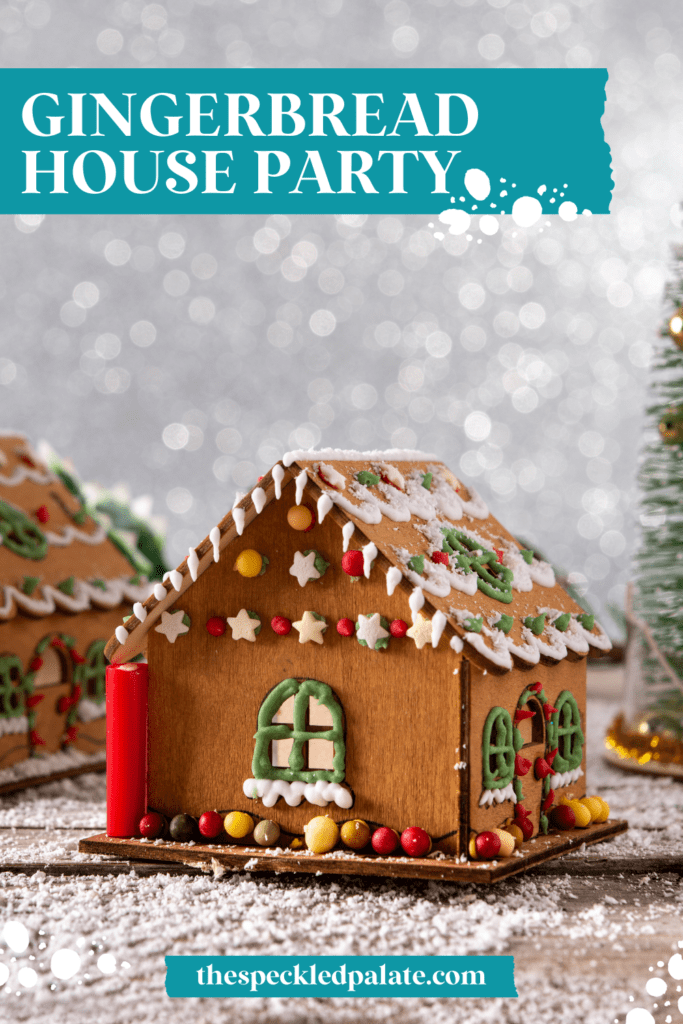 a decorated gingerbread house with frosting and candies on a table with sparkling snow in the background with the text gingerbread house party