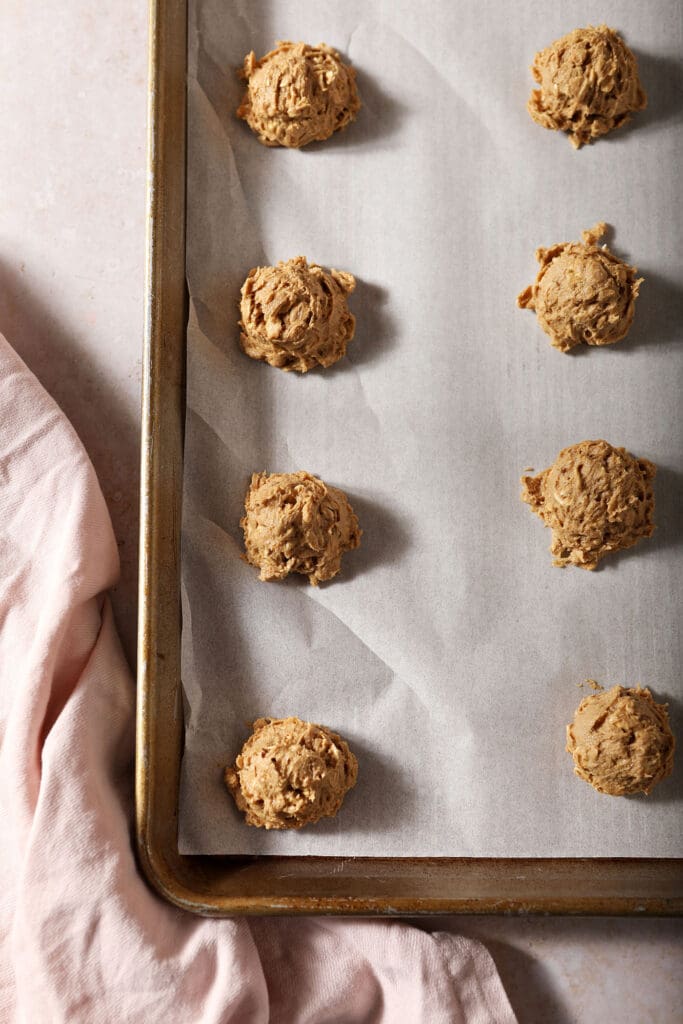 Scooped Cinnamon Oatmeal Cookies on a sheet pan before baking