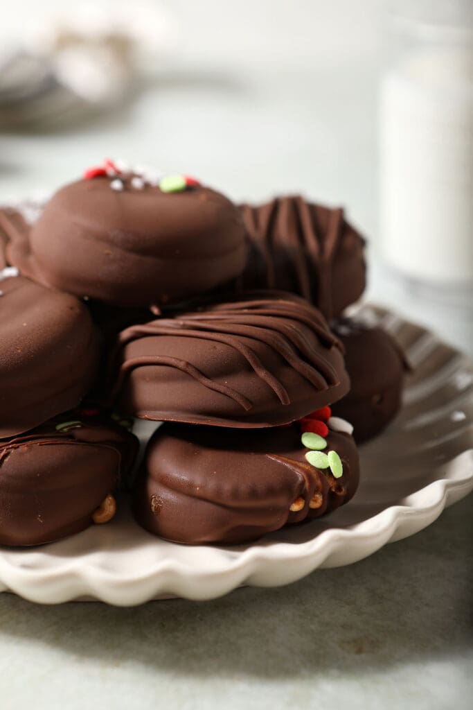 A platter of decorated Chocolate Covered Ritz Crackers on light green surface