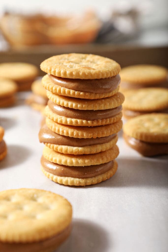 A few stacked Ritz peanut butter sandwiches on a rimmed sheet pan