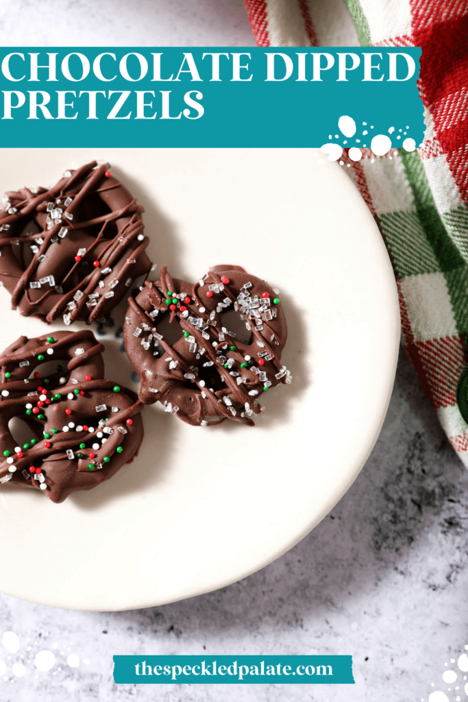 A white plate of three chocolate covered pretzels next to a green and red plaid linen with the text chocolate dipped pretzels