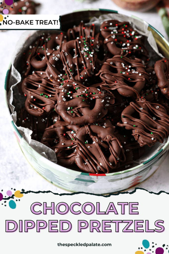 Overhead of a Christmas tree tin of chocolate covered pretzels with Christmas sprinkles with the text chocolate dipped pretzels