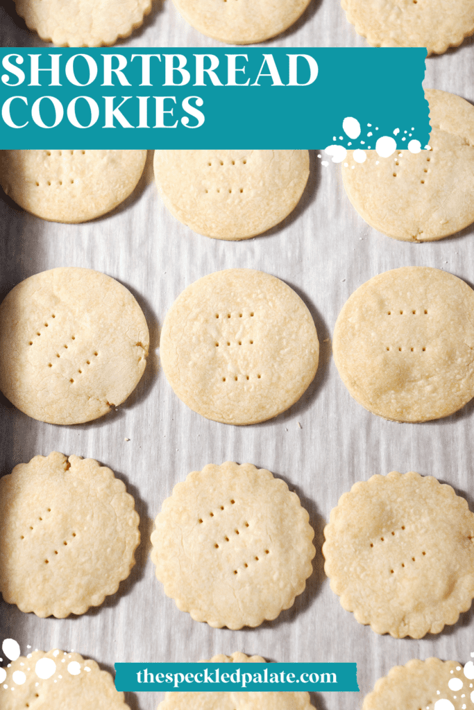 Round cookies on a sheet pan after baking with the text shortbread cookies